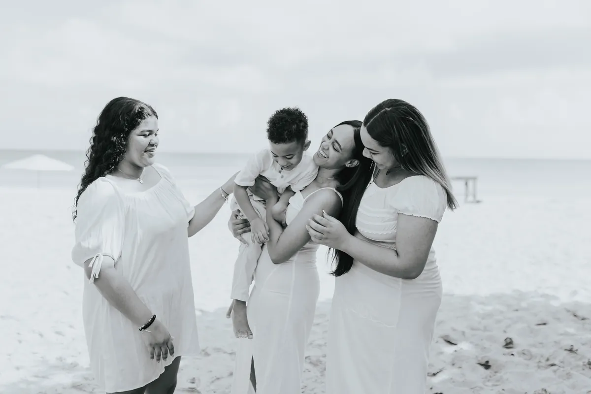 Black and white: the family laughing together by the sea