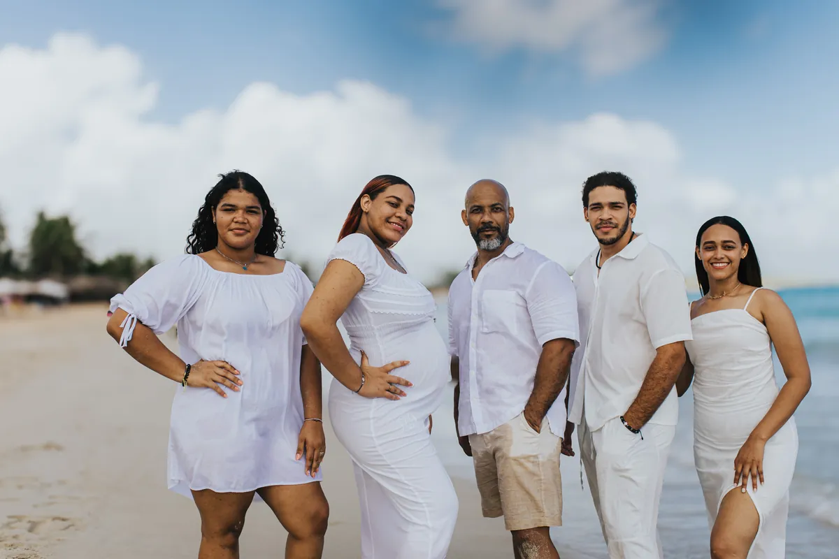 Extended family portrait on the beach, all in white