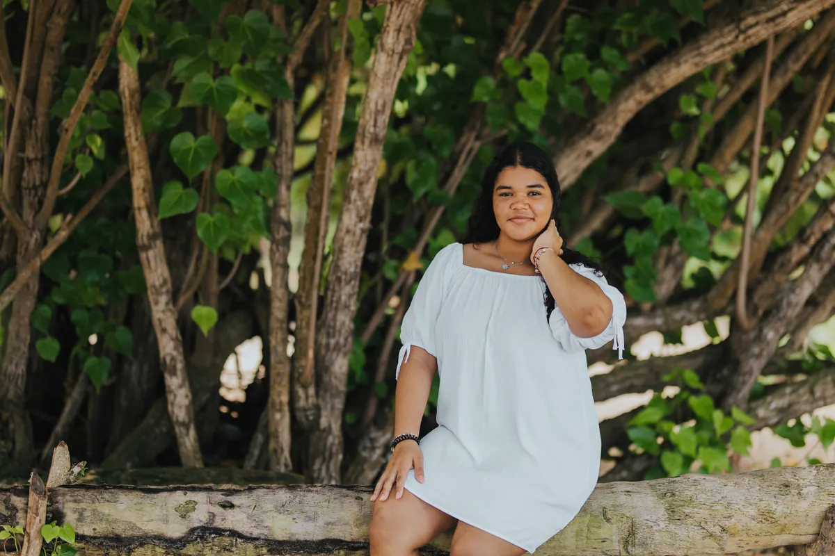 Young woman laughing in the shade of the trees