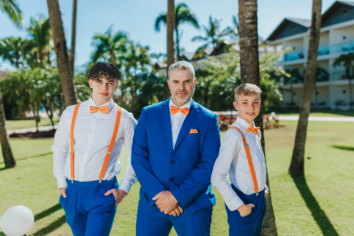 Groom with two young sons in matching orange bow ties