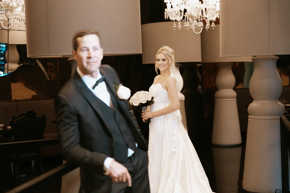 First look: the bride smiling behind the waiting groom