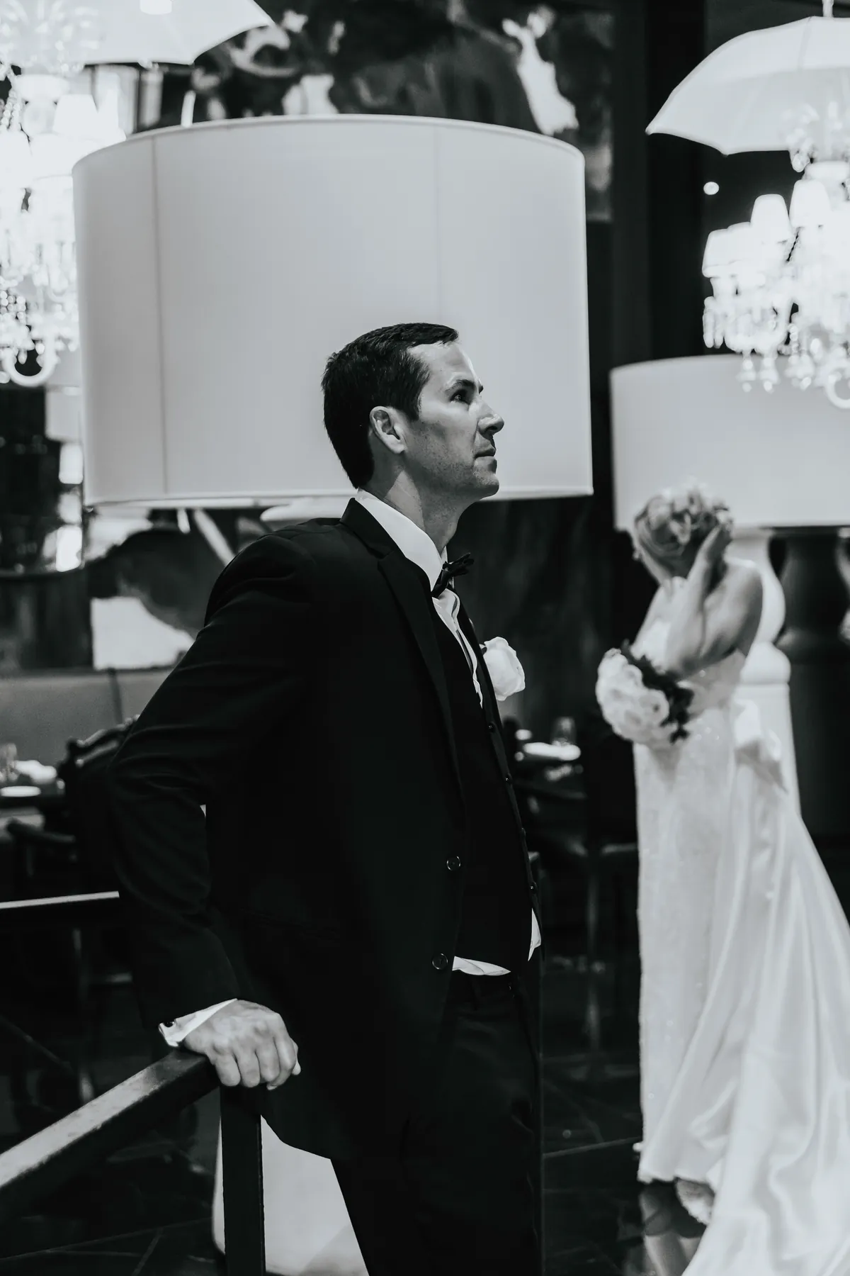Black and white: groom waiting for the first look